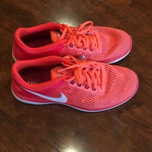 Bright orange Nike tennis shoes